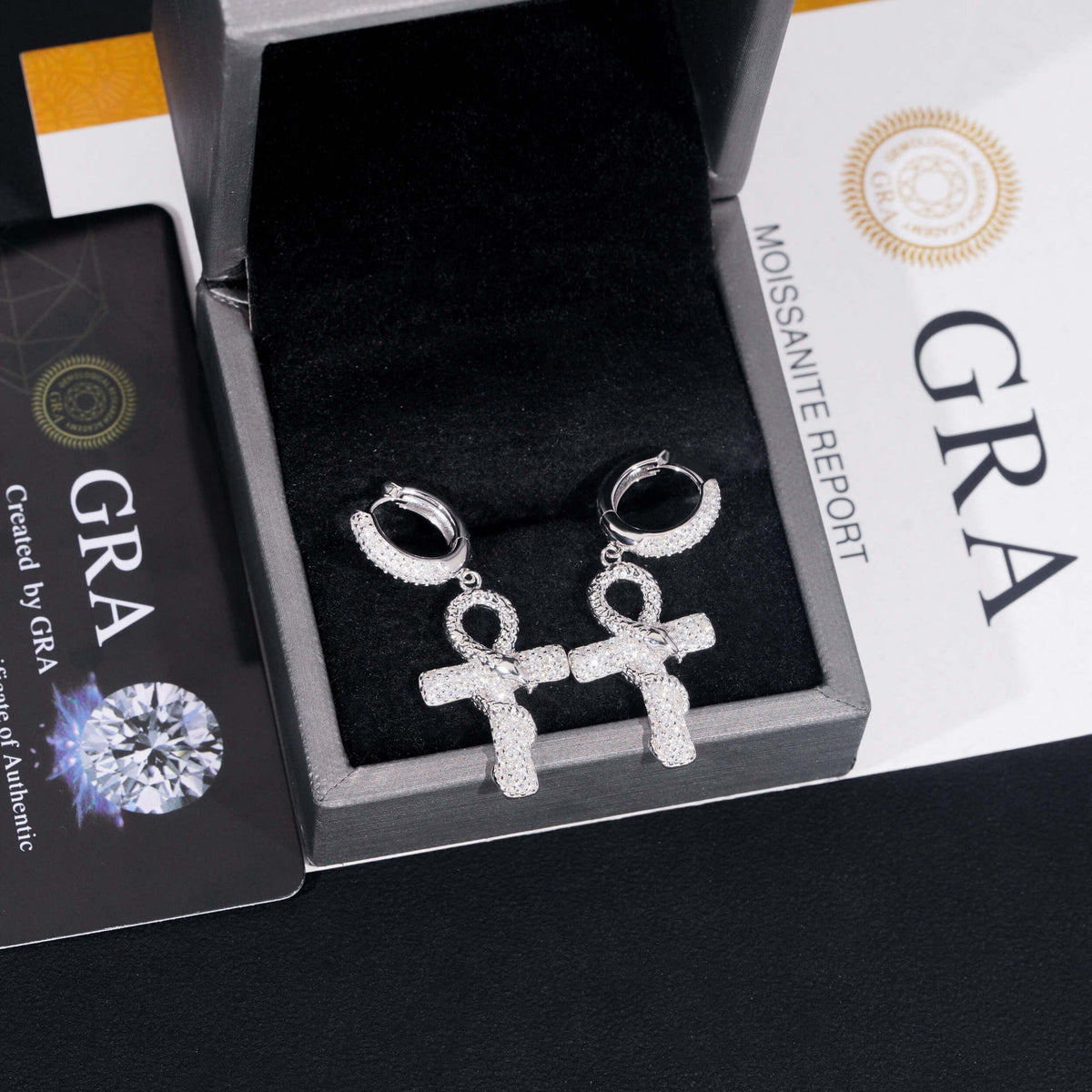 Silver iced out ankh cross snake dangle huggie hoop moissanite earrings in jewelry box with GRA certificate