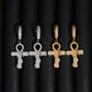 Gold and silver iced out ankh cross snake dangle huggie hoop moissanite earrings aligned on dark background