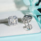 Silver iced out asscher cut halo solitaire moissanite stud earrings in box showing screw back post mechanism   