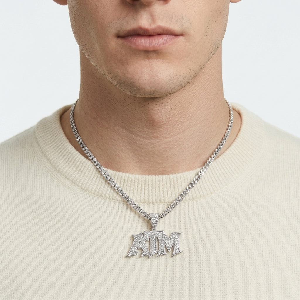 Editorial street style lookbook portrait of a model wearing an iced out ATM moissanite pendant with a cream sweater.