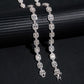 Silver iced out baguette halo and round alternating moissanite tennis chain and bracelet draped on cylinder stand