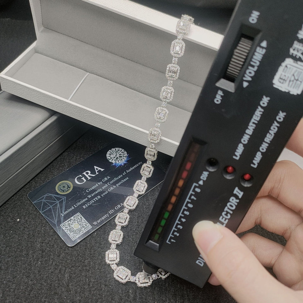 Diamond selector tester device testing silver iced out baguette halo moissanite tennis chain with GRA certificate