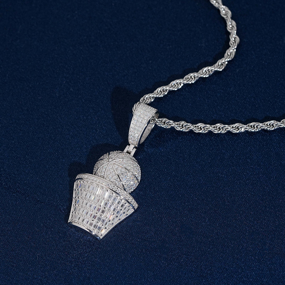 Angled view of iced out basketball and hoop moissanite baguette pendant with silver chain