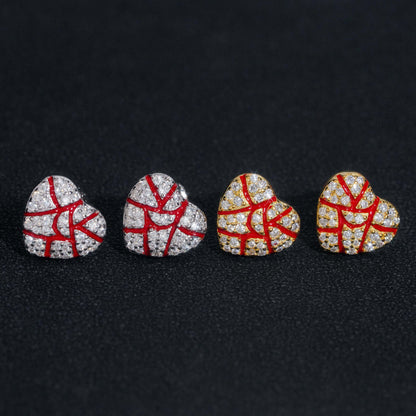 Diamond selector tester checking red enamel iced out broken heart moissanite stud earrings held in hand