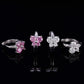 Pink and clear iced out butterfly cluster huggie hoop moissanite earrings showing hinged clasp mechanism