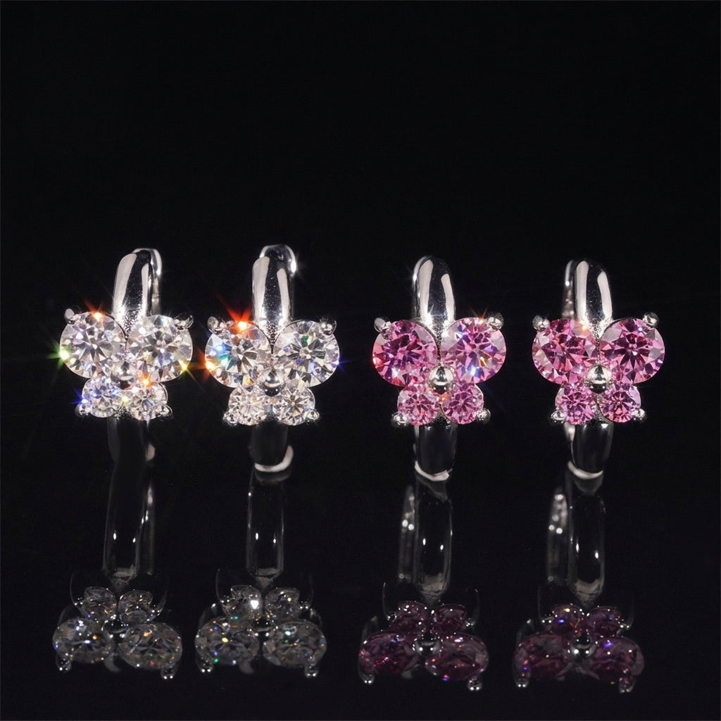 Iced out clear and pink butterfly cluster huggie hoop moissanite earrings with reflections on black glass