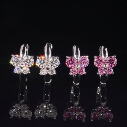 Iced out clear and pink butterfly cluster huggie hoop moissanite earrings with reflections on black glass