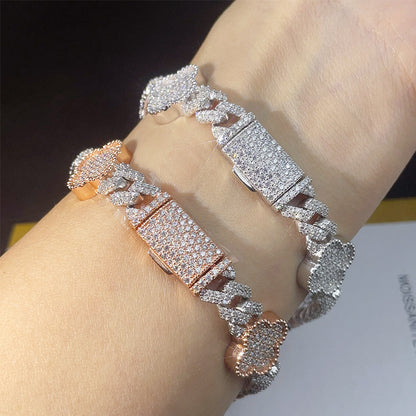 Iced out clover cuban link moissanite bracelets on wrist showing pave box clasp mechanism   