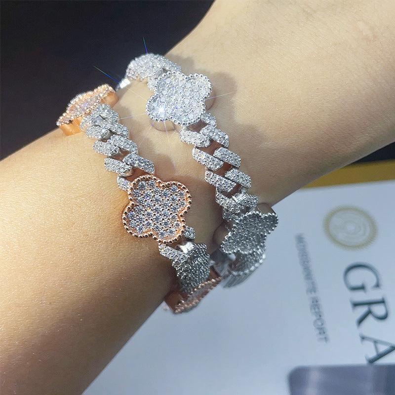 On-wrist view of silver and rose gold iced out clover cuban link moissanite bracelets with pave setting