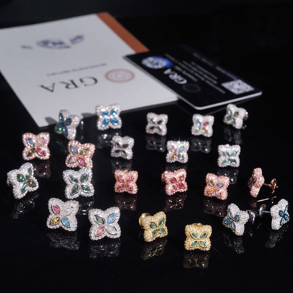 Assorted colorful four-leaf clover moissanite stud earrings arranged on GRA certificate card