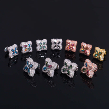 Iced out colorful four-leaf clover moissanite stud earrings in multi-color gemstone variations on black background