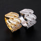 Angled view showing baguette moissanite setting on yellow gold and silver cuban link rings
