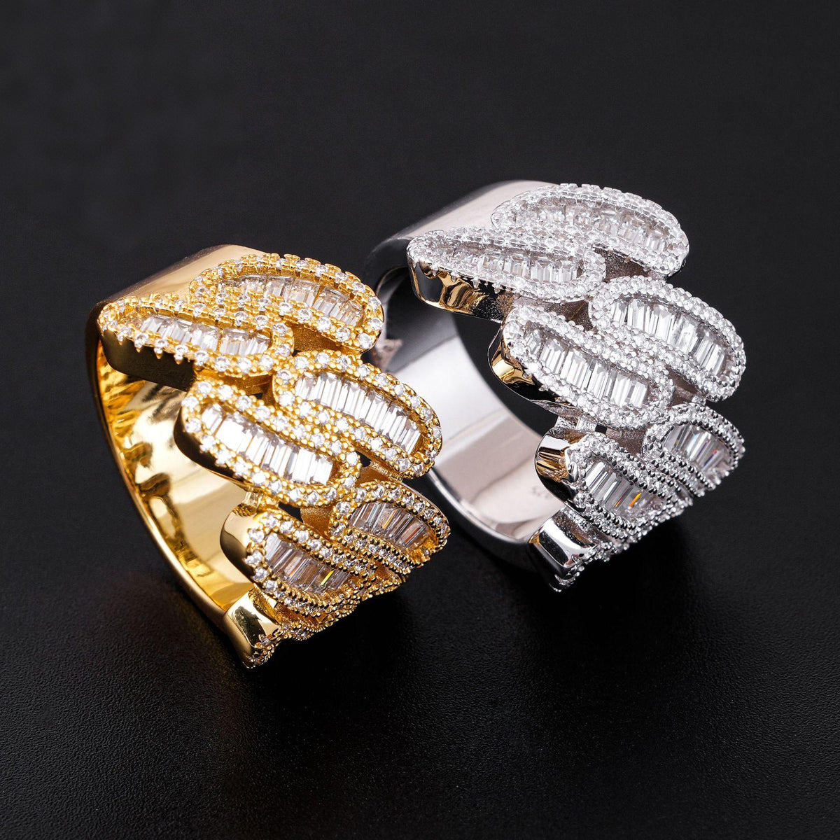 Angled view showing baguette moissanite setting on yellow gold and silver cuban link rings