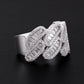 Close up view showing baguette moissanite channel setting on silver cuban link band   