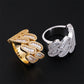 Side perspective view of iced out cuban link moissanite baguette rings on black background