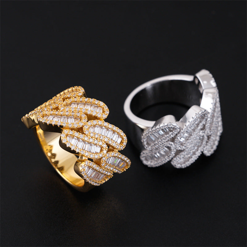 Side perspective view of iced out cuban link moissanite baguette rings on black background