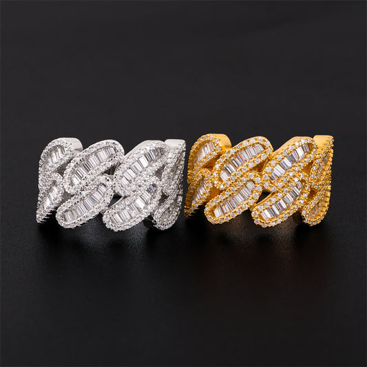 Iced out cuban link moissanite baguette rings in silver and yellow gold resting on black surface