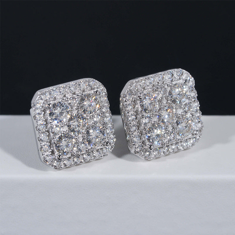 Silver iced out cushion square cluster moissanite stud earrings resting on white pedestal box