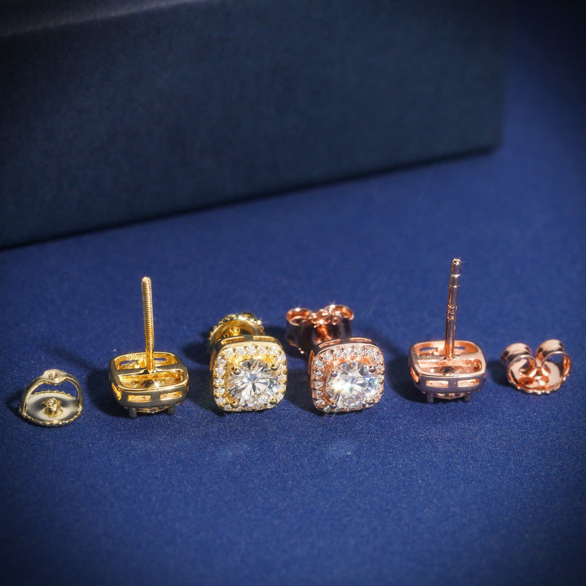 Rose gold and yellow gold iced out cushion square halo solitaire moissanite stud earrings showing posts and screw backs
