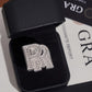 Iced out double letter RR moissanite ring displayed in black jewelry box with GRA certificate