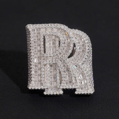Iced out double letter RR moissanite baguette ring in sterling silver isolated on dark background