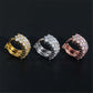 Yellow gold, white gold, and rose gold iced out double row moissanite huggie hoop earrings on black background