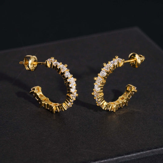Yellow gold iced out eternity C-shaped half hoop moissanite stud earrings on dark display box