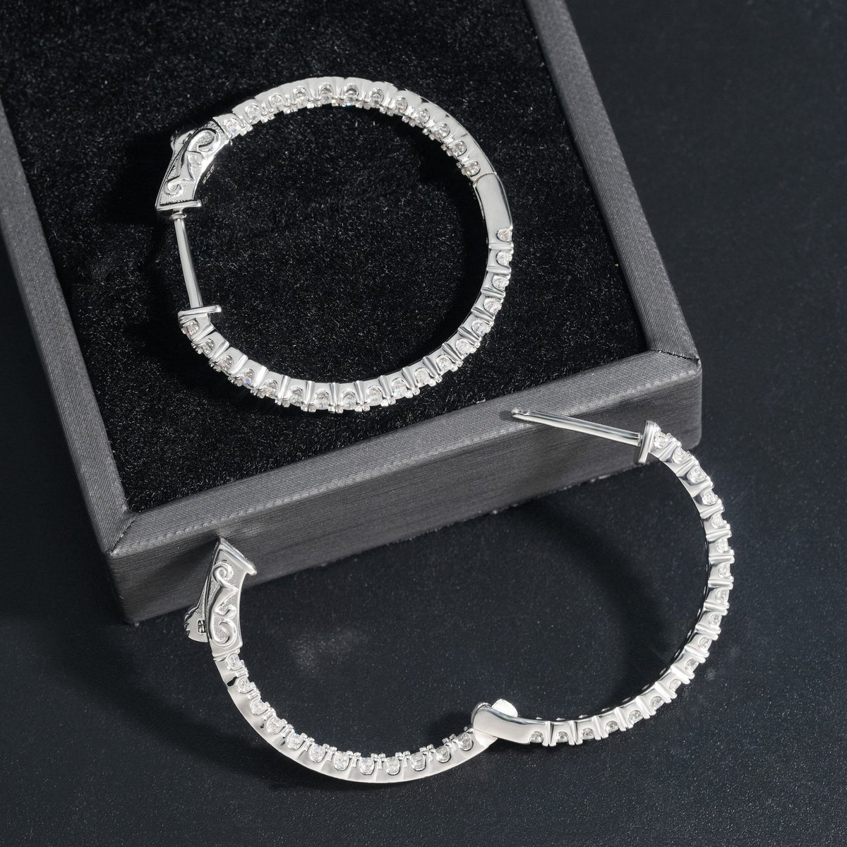 Silver iced out eternity moissanite hoop earrings showing open hinged clasp latch back mechanism
