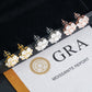 Three-tone iced out flower 7-stone cluster moissanite stud earrings displayed on official GRA report card