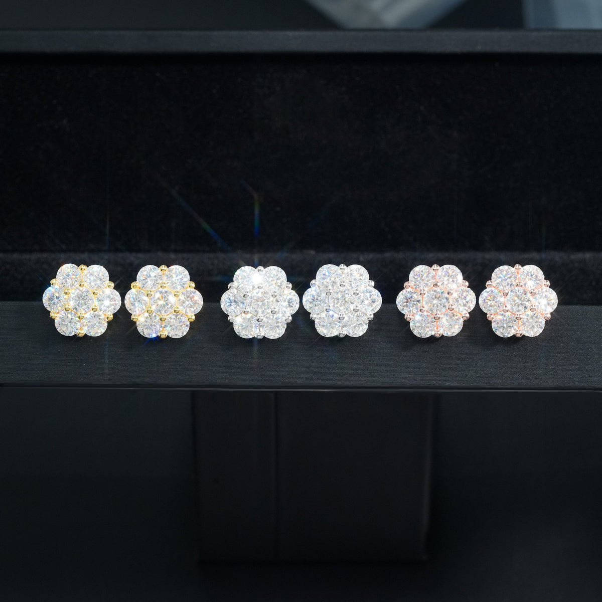 Yellow gold iced out flower 7-stone cluster moissanite stud earrings showing front setting and screw back post