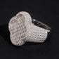 Angled view showing thick pave band and clover motif of moissanite ring