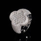 Front view showing pave moissanite clover centerpiece of iced out baguette ring