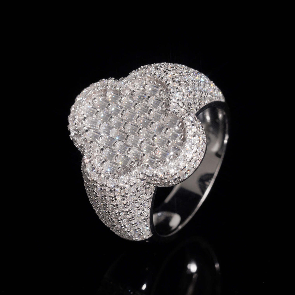 Front view showing pave moissanite clover centerpiece of iced out baguette ring