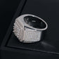 Close up hand held view showing four-stone cluster centerpiece and pave setting of moissanite ring