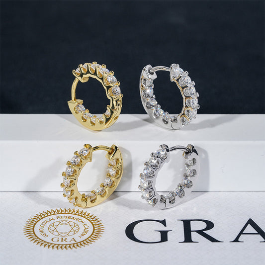 Iced out gold and silver moissanite tennis hoop earrings displayed on GRA report paper