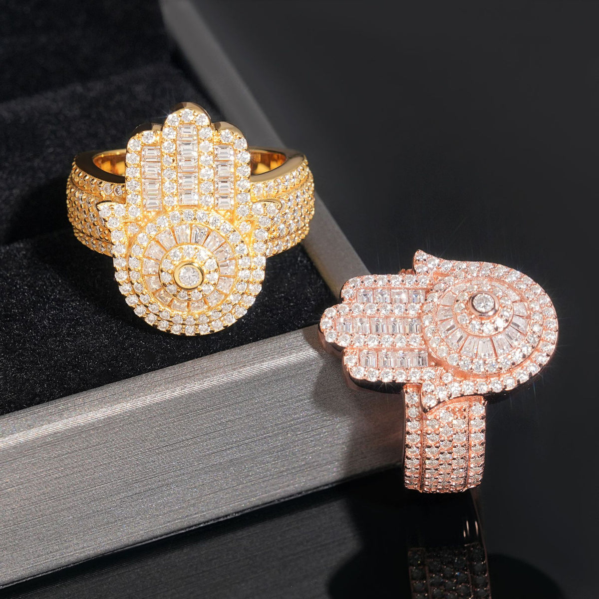 Close up view showing pave moissanite hamsa hand centerpiece and wide band detail