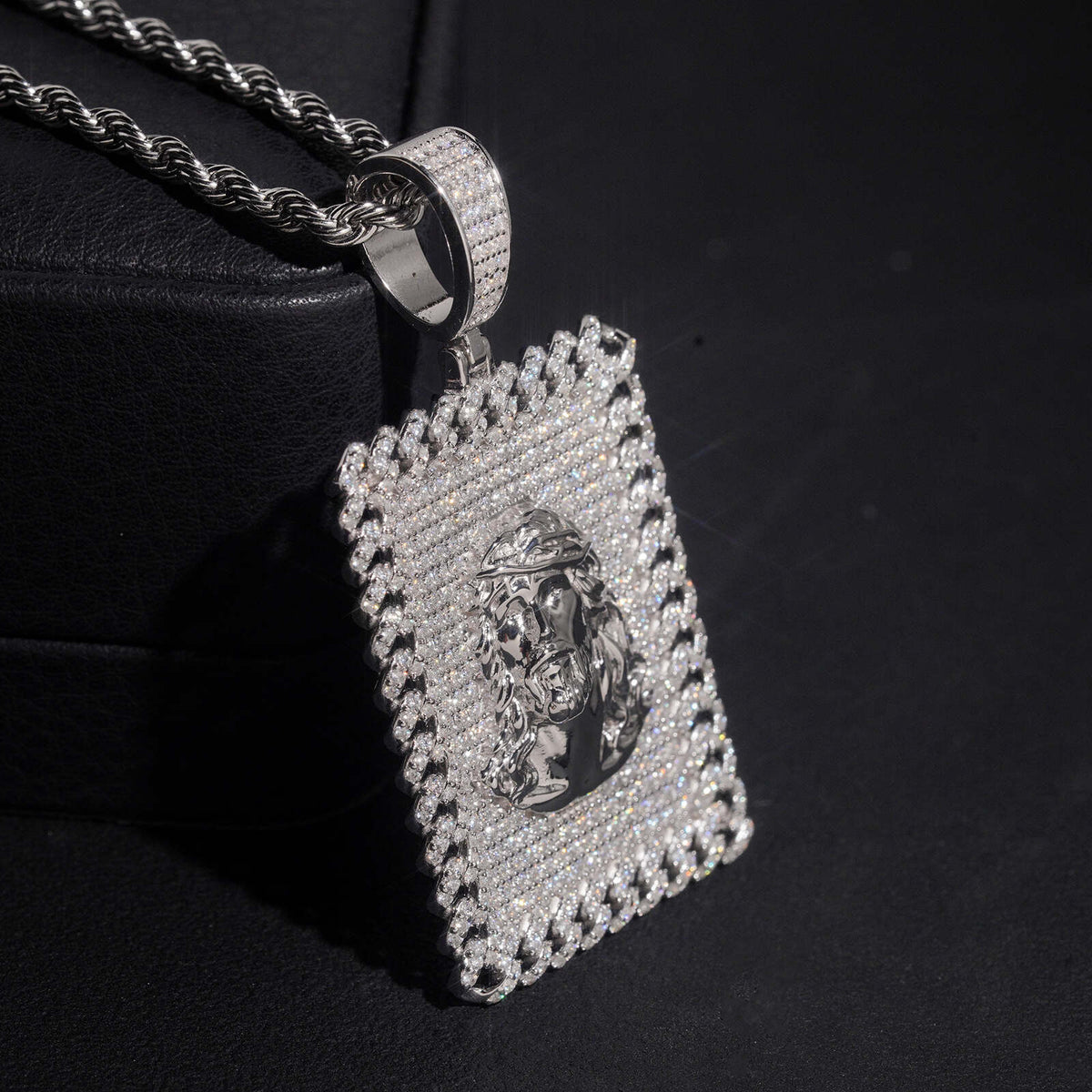 Angled view showing iced out bail and textured jesus portrait on dog tag pendant