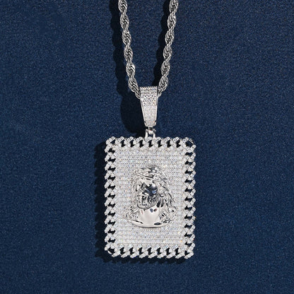 Iced out jesus piece moissanite dog tag pendant in sterling silver on rope chain resting on dark blue background