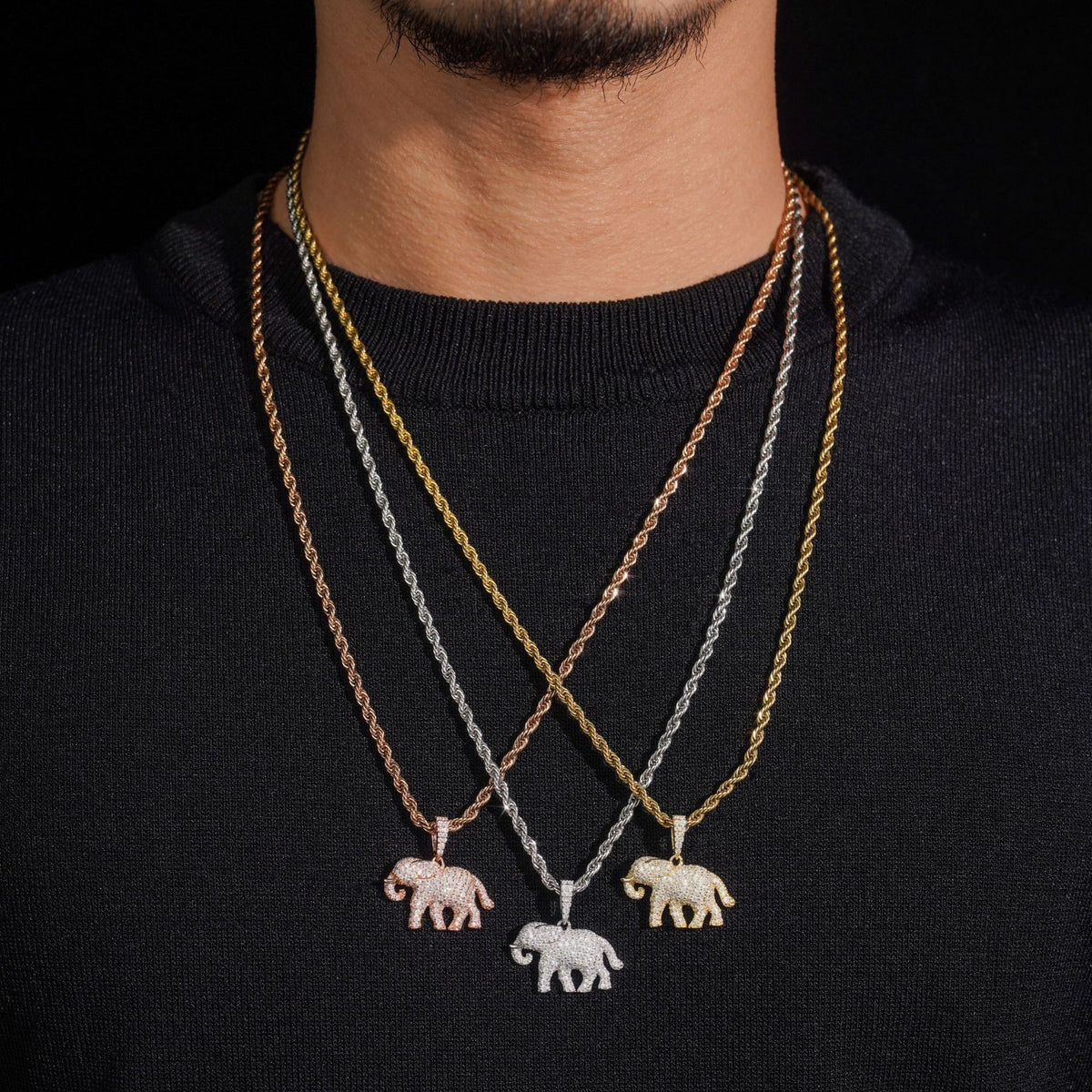 Model wearing layered S925 sterling silver iced out moissanite elephant pendant necklaces
