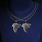 S925 silver iced out moissanite falcon bird logo pendant necklaces in two sizes displayed on neck bust