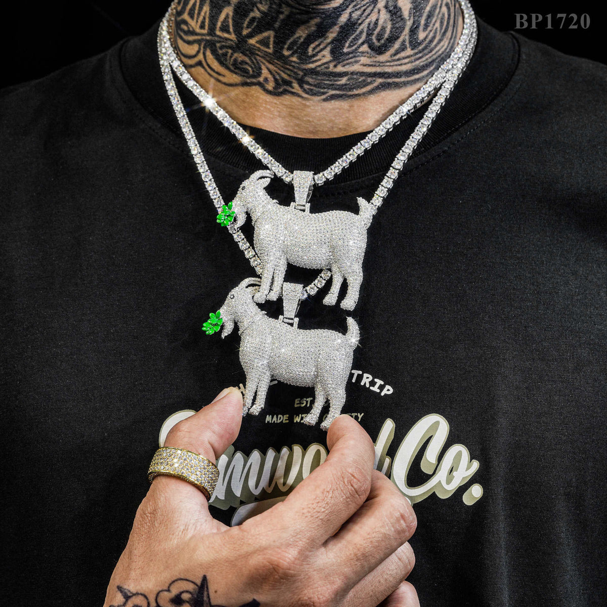 Model wearing layered 925 sterling silver iced out moissanite GOAT pendant necklaces with tennis chain   