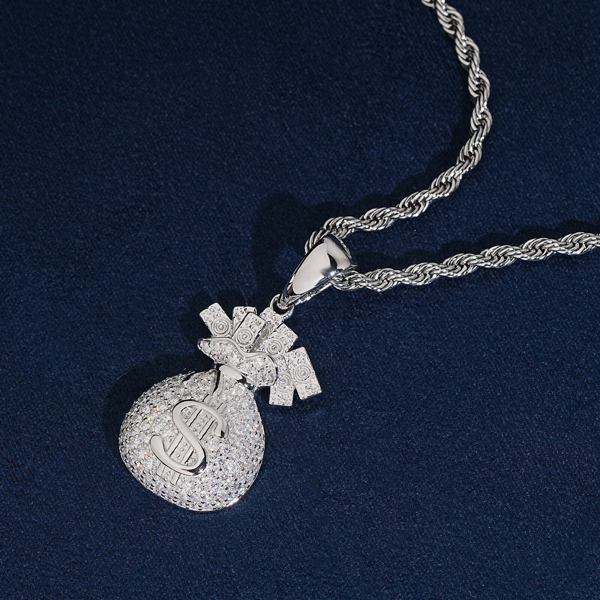 Angled view of iced out money bag dollar sign moissanite pendant with silver rope chain