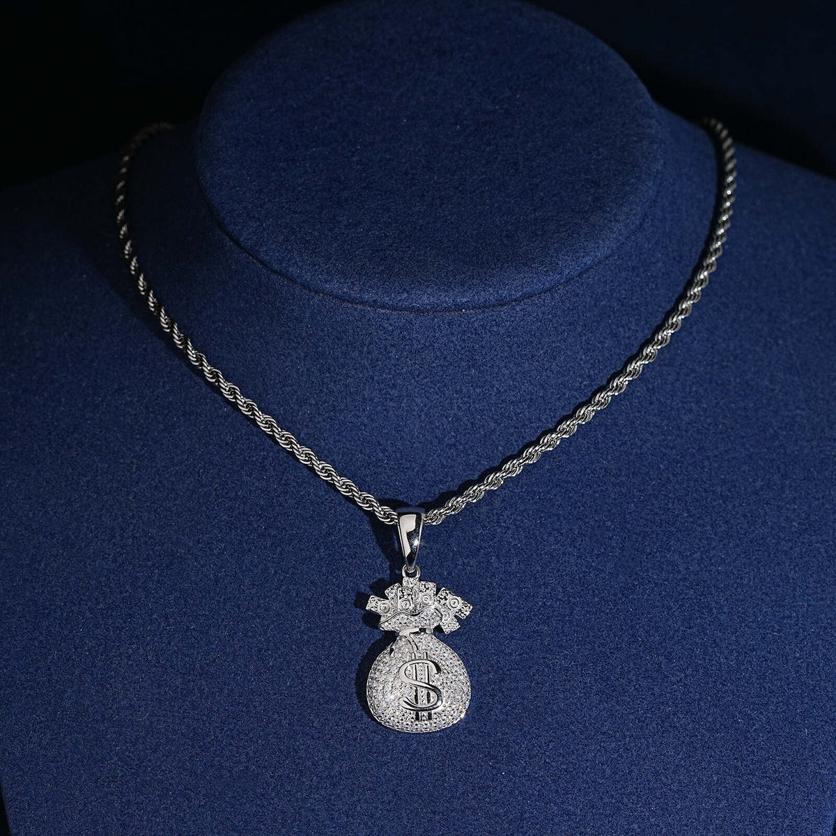 Iced out money bag dollar sign moissanite pendant displayed on jewelry mannequin bust   