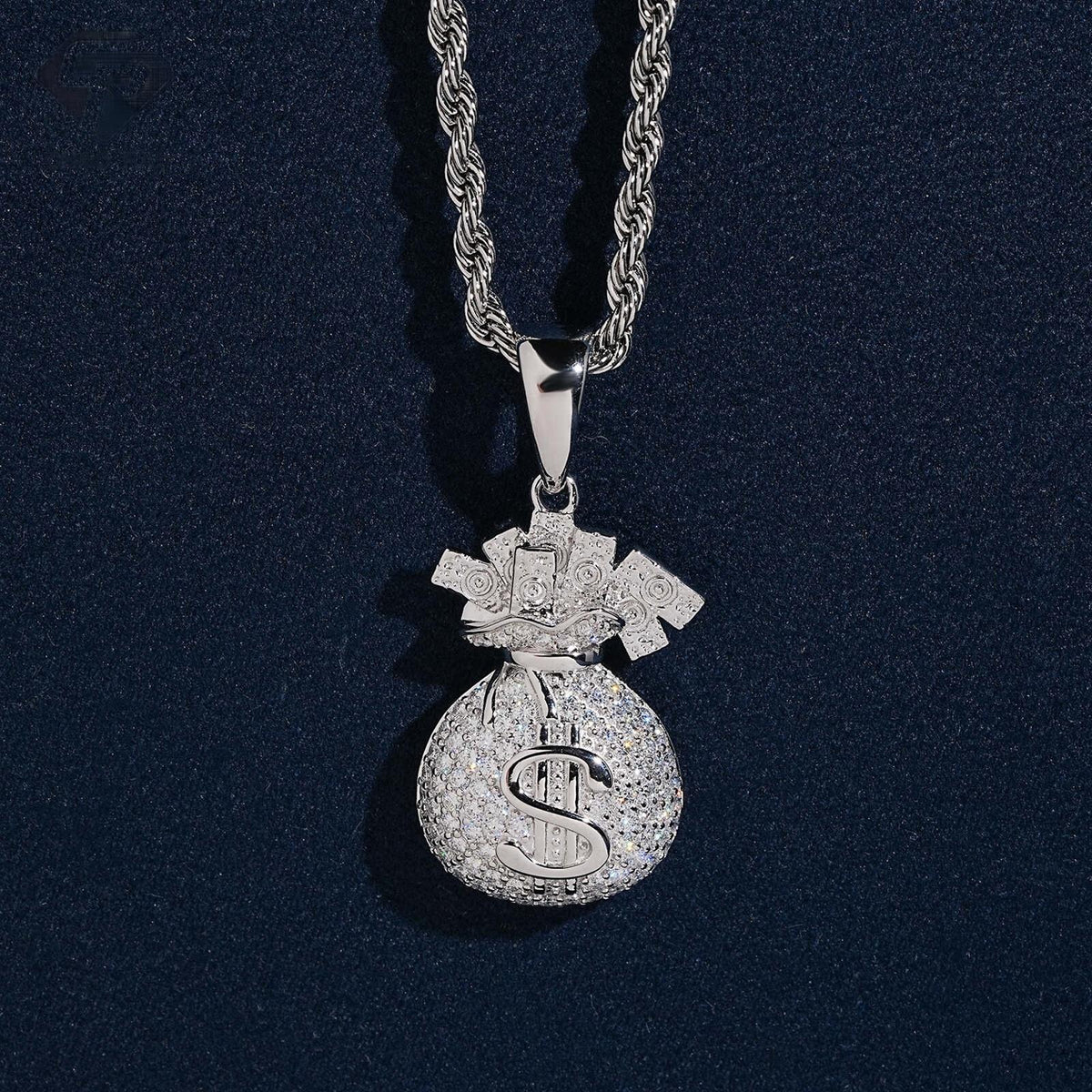 Iced out money bag dollar sign moissanite pendant in sterling silver on rope chain resting on dark blue background