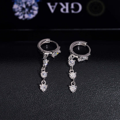 Pair of yellow gold iced out pear cut and 3-stone drop dangle huggie hoop moissanite earrings on GRA card