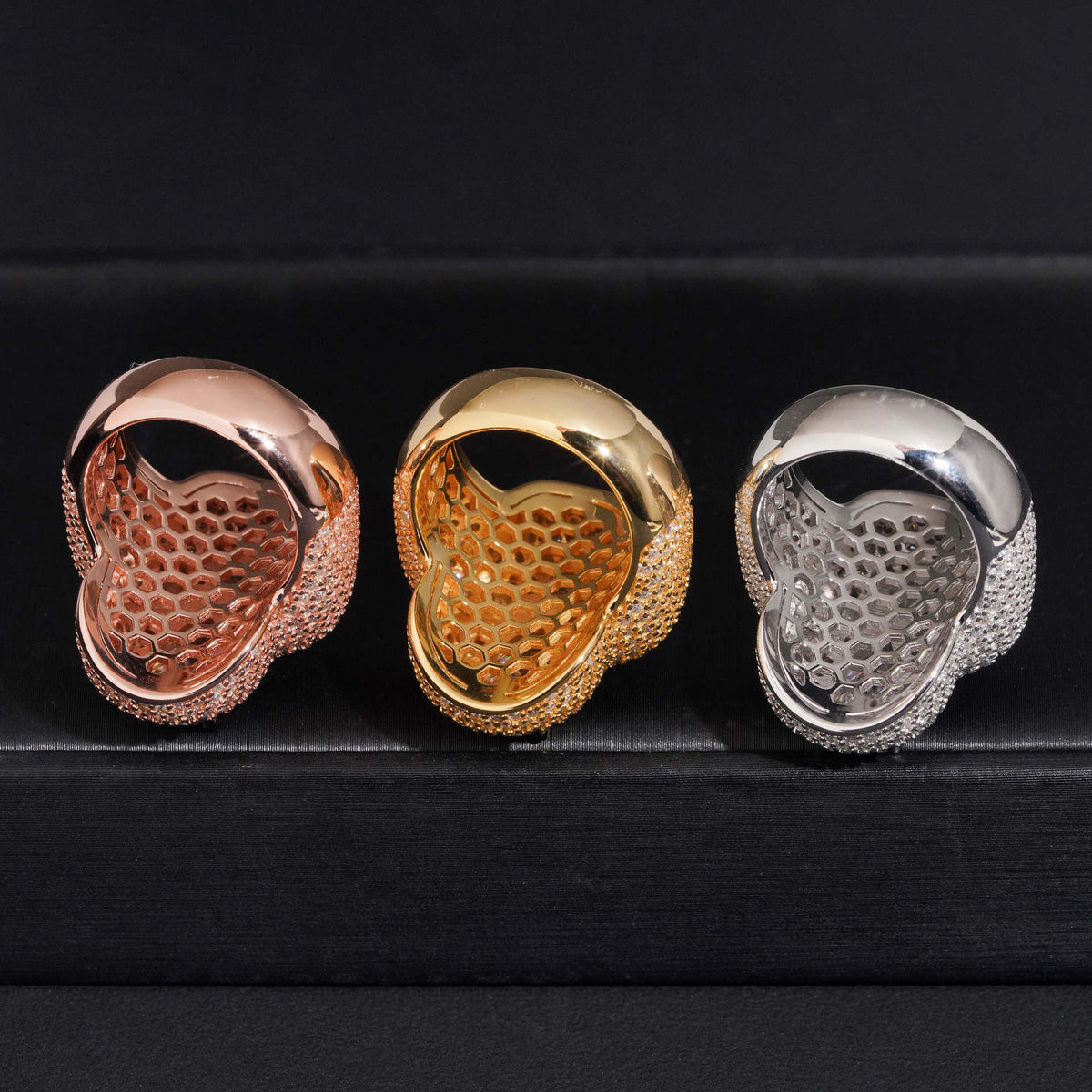 Bottom view showing hollow lattice band construction of three color moissanite clover statement rings