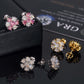 Pink, white, and yellow gold iced out flower 7-stone cluster moissanite stud earrings on GRA certificate   