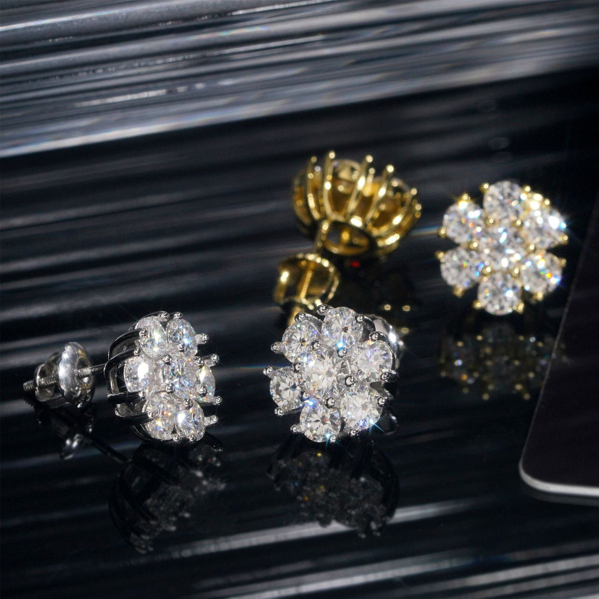 Silver and gold iced out flower 7-stone cluster moissanite stud earrings showing screw back post mechanism