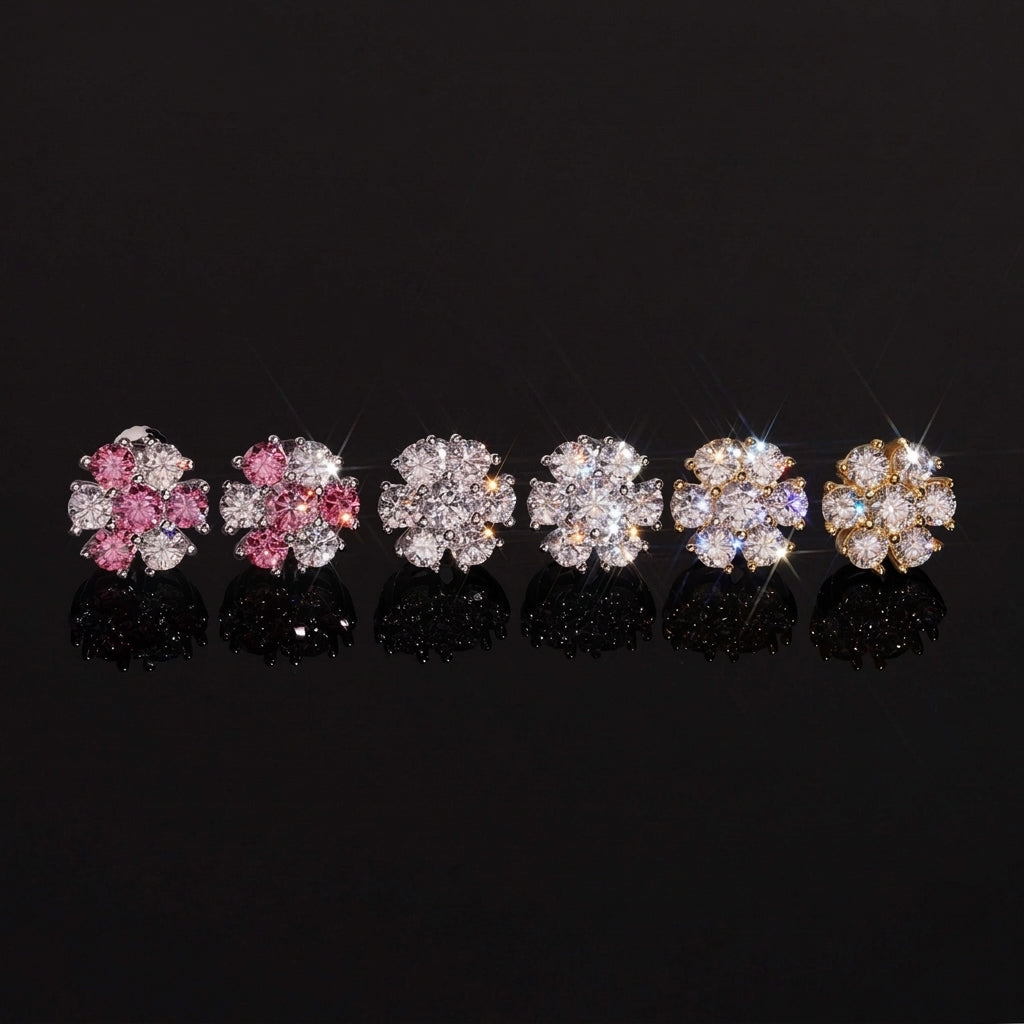 Iced out pink and white flower 7-stone cluster moissanite stud earrings in pink, silver, and gold on dark surface