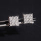 Silver iced out princess cut square cluster moissanite stud earrings held by tweezers